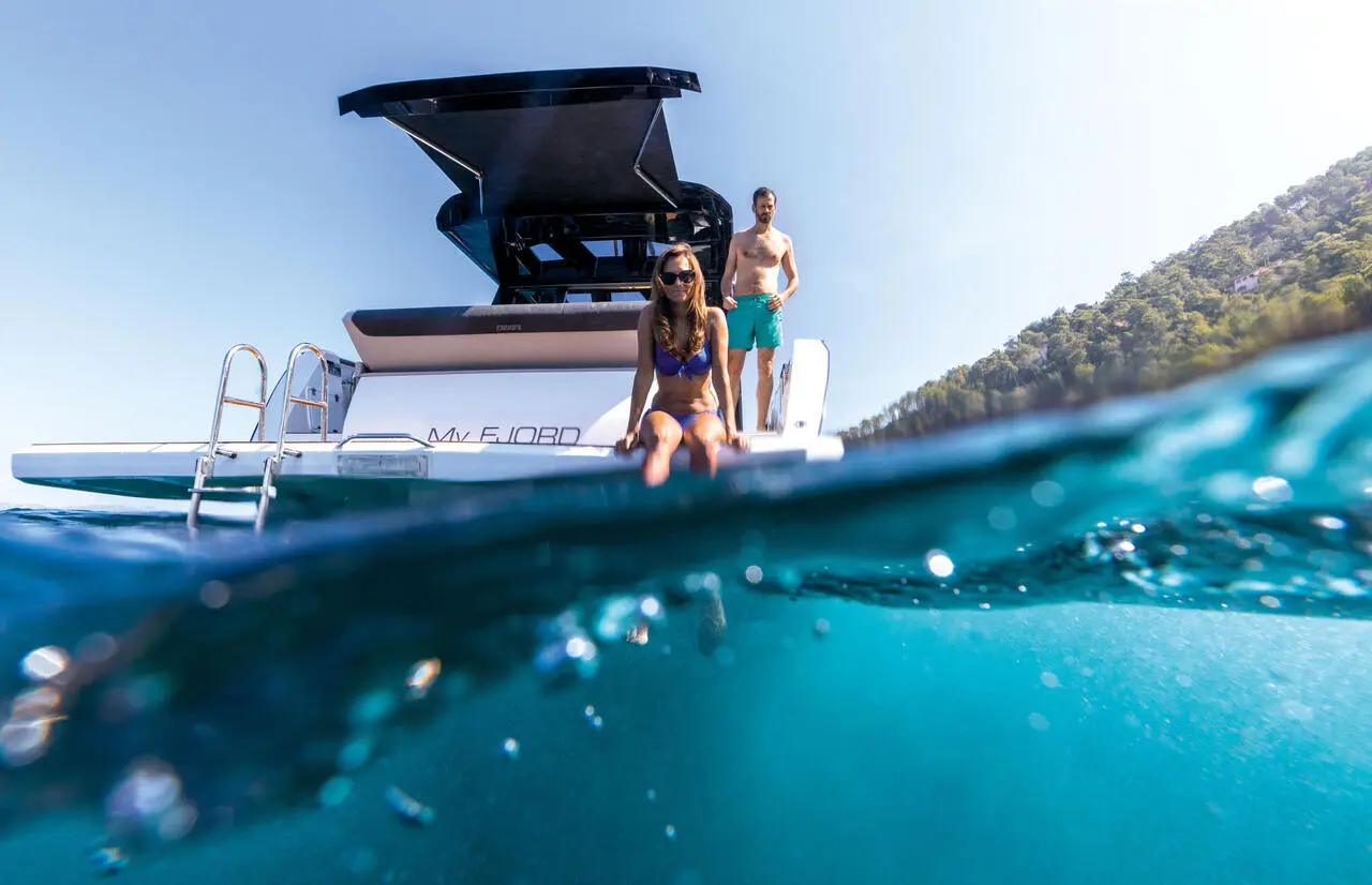 Couple enjoying yacht on the water.